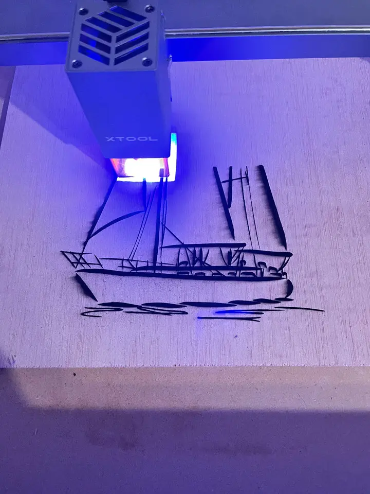 Sailboat design being laser engraved