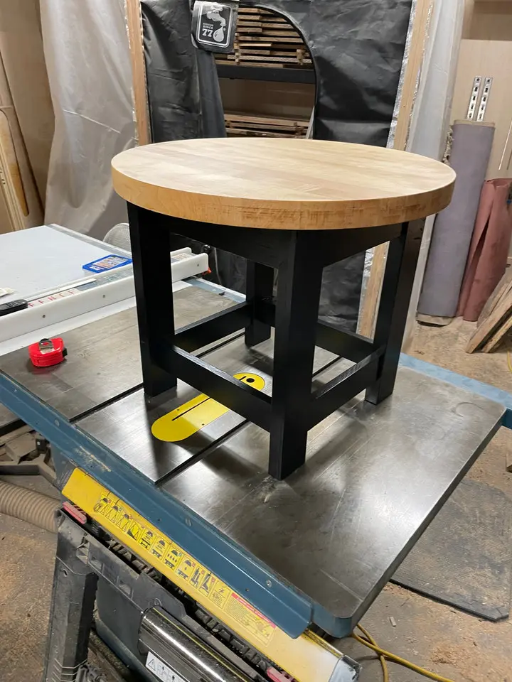 Round wooden side table in progress in the workshop